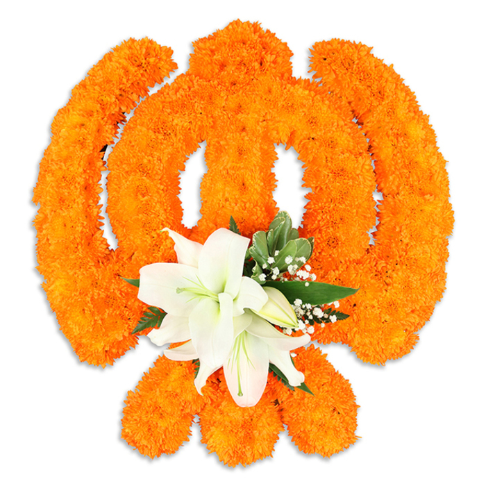 An elegant Ik Onkar symbol is formed entirely from a dense field of vivid orange marigold blooms, each tiny pompom placed to create the flowing line and distinctive dot that declare One God. The marigolds' compact texture gives the symbol a warm, woven surface that seems to shimmer in soft, even light, and the composition is executed with exacting symmetry so the numeral stroke and crescent-like curves remain crisp against the clean white background. At the lower centre of the composition a refined cluster of white lilies offers a calm counterpoint: at least two prominent, fully open lilies with gently curved petals, pale green throats and yellow stamens, ringed by smaller white buds that add a quiet promise of unfolding. Interspersed fresh green foliage - the glossy, rounded leaves that echo salal - and filigree sprays of baby's breath provide depth and a cooling frame to the orange field, softening the edges and adding air between the dense marigold work. A subtle drop shadow beneath the piece gives it a three-dimensional presence as a ceremonial display rather than a flat graphic. The overall impression is devotional and celebratory, the saffron-orange marigolds speaking to traditional offerings while the white lilies bring serenity and fragrance. This floral Ik Onkar would be a respectful adornment for Gurpurab, home shrines or temple decorations in the Grove Park and Lewisham area, and it reflects the careful, community-minded craftsmanship of a florist accustomed to seasonal blooms and local ceremonies near Grove Park Nature Reserve and the station.