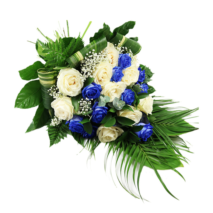 A luxurious memorial spray in rich blue and soft white is captured against a bright white backdrop, every petal and frond clearly defined, as if laid out in a quiet chapel near Grove Park. The shape is distinctly cascading, with a rounded, full top that narrows towards a graceful tip at the lower right, forming a classic teardrop silhouette associated with formal funeral and sympathy designs. The centre of the arrangement is densely packed with fully bloomed roses, their velvety petals opening wide. Vivid sapphire blue roses, almost electric in intensity, are interspersed with an equal abundance of creamy white and ivory roses. The two tones are woven together so that blue blooms nestle beside white, creating a continuous, flowing pattern of contrast rather than sharp blocks of colour. Soft tufts of white baby's breath are tucked between the roses, creating little pockets of air and light, like fine lace between heavier fabrics. Around this central mass of flowers, a rich collar of greenery forms both structure and movement. Bright green, feather-like fern fronds extend from the upper left, adding height and a hint of wildness. Broad, dark green leaves provide a polished, glossy background that makes the roses stand out more vividly. Long, graceful palm fronds issue from the lower right, their slender, arching lines defining the cascade and drawing the eye downwards. Threaded discreetly among the foliage are bluish-green eucalyptus-style sprigs, which add another textural layer and a cooler, muted tone. Several broad green leaves have been carefully folded and wrapped into horizontal bands, resembling refined ribbons of foliage and demonstrating skilful craftsmanship. The overall feeling is one of solemn beauty and refined taste, an arrangement that could easily be chosen by a Grove Park family as a central tribute at a funeral, cremation, or remembrance service.