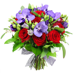 From Grove Park Florist comes this vibrant, hand-tied bouquet, photographed against a pristine white backdrop. It is a lush, full arrangement built around several velvety red roses and a collection of purple Vanda orchids, instantly recognized by their broad petals and speckled pattern in deep violet tones. Nestled among these anchors are sprays of lisianthus in soft purple hues, some buds, some open, adding gentle lavender tones and a silvery sheen that lightens the palette. The bouquet is surrounded by dense green foliage-broad, glossy leaves and delicate wisps of eucalyptus-to provide volume and a natural mirror for the blooms. The stems are neatly gathered and secured at the base with a decorative netted ribbon in dark plum, which forms an open, airy bow and a modern finish to the design. This opulent arrangement radiates romance, celebration, and refined luxury, making it ideal as a luxurious gift, a dramatic wedding accessory, or a showpiece for a special dinner. It is available for same-day delivery across Grove Park and surrounding communities, bringing freshness and a touch of theatre to birthdays, anniversaries, or heartfelt thank you notes. With every stem carefully chosen and placed, this bouquet shows the skill and devotion of a local florist who knows how to craft emotion into color and texture.
