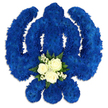 A bold Sikh Khanda floral arrangement dominates a white studio background, its powerful shape defined entirely by deep royal blue blooms. The circular chakkar, the tall central sword, and the two symmetrical, curved kirpans are formed by a tightly packed layer of blue chrysanthemums, each small flower head pressed closely to its neighbours so that the emblem appears as a single, unified form. The texture is thick and cushion-like, with subtle variations in petal angle catching the light and creating a sense of movement across the surface. The blue colour is striking and reverent, evoking both devotion and calm, much like the atmosphere during a quiet moment at a Gurdwara serving the Grove Park community. Nestled at the base of the central blade is a delicate contrasting feature: three ivory-white roses, fully open yet still crisp, gathered together at the heart of a small cluster. Around them, clouds of tiny white filler flowers add softness, while a ring of rich green foliage peeks out beneath, giving structure and framing the lighter tones. This white and green accent breaks the expanse of blue with a suggestion of purity, remembrance, and the gentle love of family and friends. The tribute appears perfectly symmetrical and carefully finished, as though it has just been completed by experienced hands at Grove Park Florist, ready for delivery to a funeral service, Gurdwara, or memorial gathering. The overall impression is one of quiet strength and heartfelt respect: a floral Khanda designed to honour a Sikh life with colour, symbolism, and the timeless language of flowers.