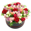 The image presents a sumptuous, rose-filled hat box designed with modern elegance and romantic flair. A sleek black round box, neatly circled at the base with a thin red band, is filled to the brim with roses formed into a generous domed bouquet. Against a spotless white background, the colours take centre stage: classic deep red roses blend smoothly with blush pinks, ivory and cream blooms, bright fuchsia tones, warm peach and coral shades, and sophisticated lavender or mauve roses. Every bloom appears freshly opened or on the verge of unfolding, with velvety petals layered in soft spirals that invite the eye to follow their curves. Smaller spray roses are interlaced among the larger heads, adding clusters of tiny buds and giving the arrangement a multi-dimensional, textured appearance. Slim, glossy green leaves peep through here and there, offering flashes of freshness and helping to define the gentle curve of the dome. The overall effect is lush yet meticulously balanced, as if created by an experienced Grove Park florist who understands both romance and restraint. One can easily picture this hat box arriving as a same-day delivery to a home near Grove Park station, a riverside flat along Strand-on-the-Green, or a cosy restaurant table where it becomes the evening's focal point. The mood it conveys is intimate celebration-ideal for anniversaries, special birthdays, or a grand romantic gesture-capturing the essence of a handcrafted arrangement that speaks of devotion, appreciation, and the quiet luxury of beautifully arranged fresh roses in the heart of Grove Park.