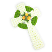 A meticulously shaped three-dimensional Celtic cross crafted entirely from fresh flowers, seen from a slightly elevated angle against a crisp white background. The main body of the cross is built from tight, plush clusters of pure white spray chrysanthemums; their tiny petals create a soft, cushion-like surface that reads as both dignified and tender. Interlacing the white are vivid apple-green button chrysanthemums, placed with precision to outline the circular ring at the cross's centre and to fill alternating segments along the arms, their rounded, almost tactile heads adding lively texture and a bright, modern contrast. At the very heart where the arms meet sit three fully opened orange-yellow roses - warm, golden petals that glow against the cool whites and greens - gently cupped and framed by a few deep green fern fronds that add slender, elegant lines. Soft studio lighting picks out the subtle sheen on rose petals and the powdery, clean scent one imagines from the chrysanthemums, while the overall three-dimensional form casts delicate, natural shadows that emphasize depth. The arrangement communicates quiet remembrance: a sympathy tribute or funeral cross that nods to Celtic symbolism and Irish roots without ceremony, its colours echoing the green, white and gold of an Irish palette. As a local florist familiar with Grove Park's calm streets and the nearby Nature Reserve and Grove Park station, I picture this arrangement placed with care at a church or graveside service, the craftsmanship intended to offer comfort through texture, colour and thoughtful composition rather than words alone.